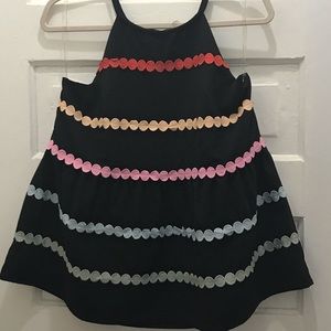 Black peplum top with color dot detail